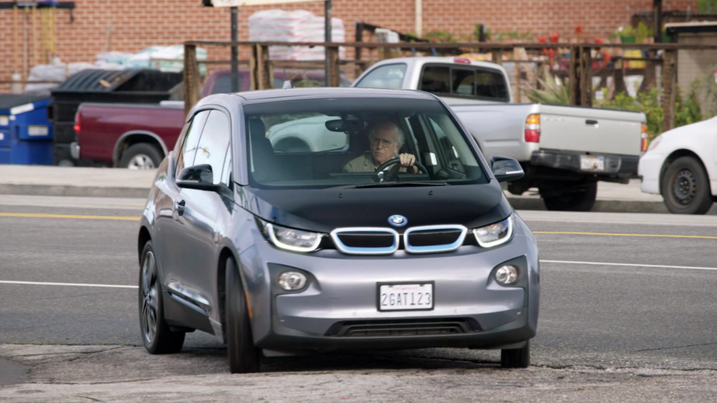 Larry David driving BMW i3