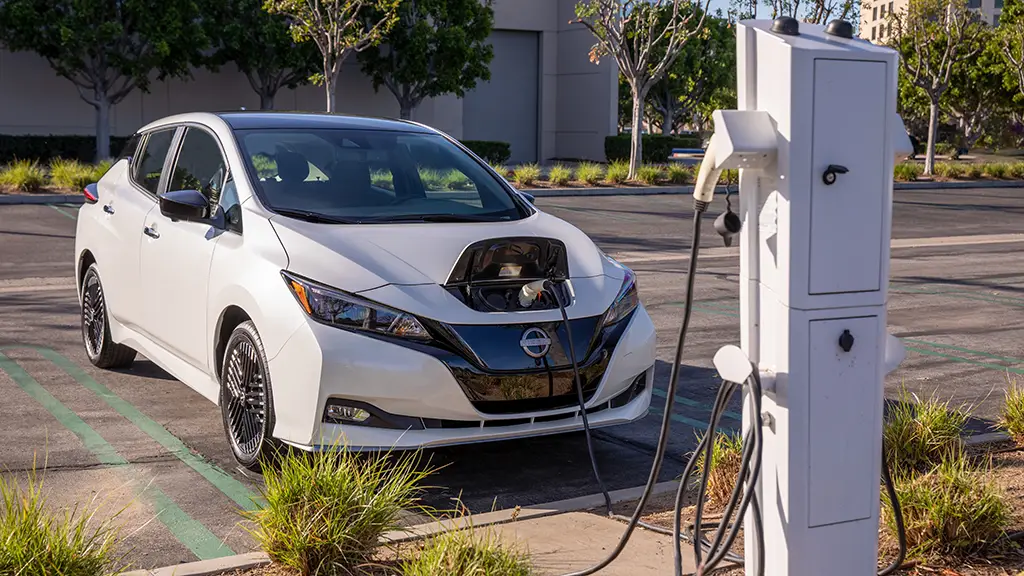 A 2023 Nissan LEAF electric car charging at a charging station. The 2024 Nissan LEAF model looks pretty much the same. 
