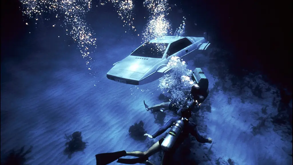 The Lotus Espirit S1 that has been modified to "Wet Nellie" (a submarine car) is seen underwater with two divers approaching. 