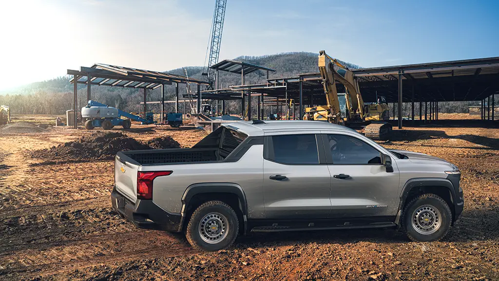We see a silver Silverado EV pickup truck at a worksite. 