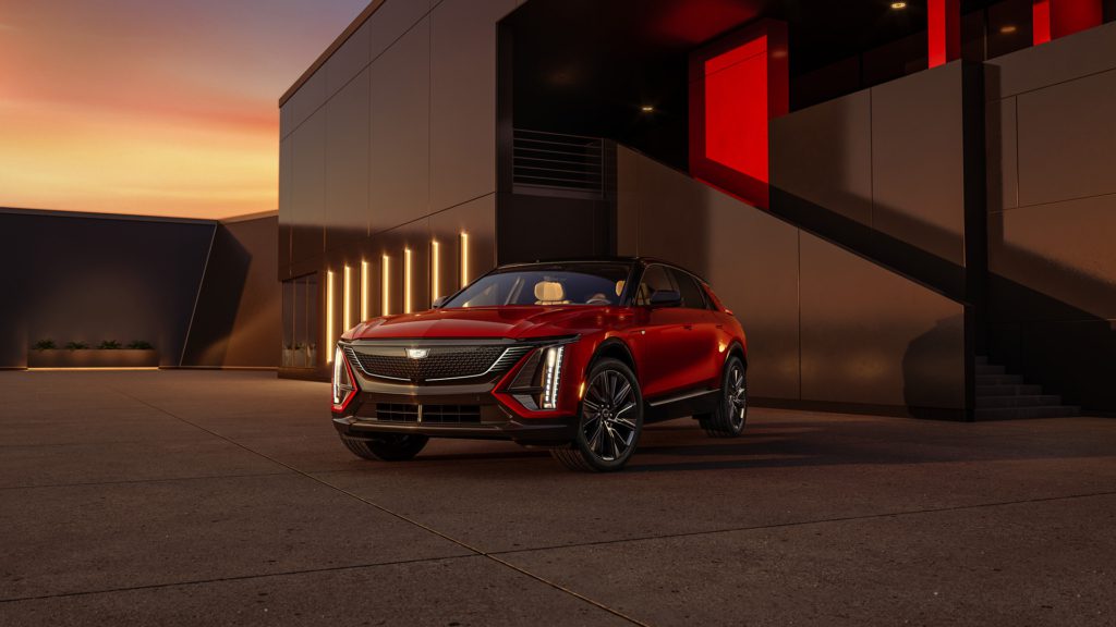 Red 2024 Cadillac Lyriq in front of what appears to be a postmodern industrial building