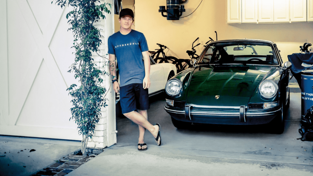 Patrick Long standing next to a vintage "Irish Green" Porsche 911