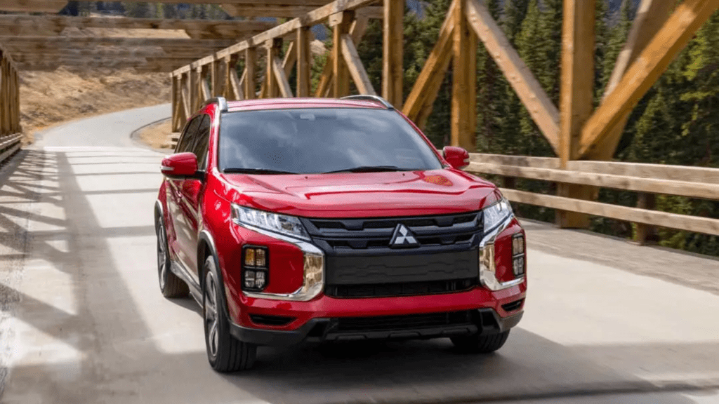 Mitsubishi Outlander (red) driving across a bridge