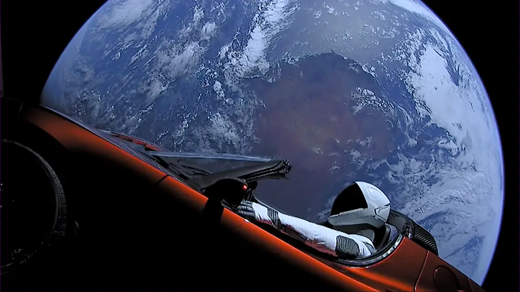 Elon's red Tesla Roadster which was mounted to the Falcon Heavy Rocket and shot into outer space. You can see the earth placidly behind the car. 