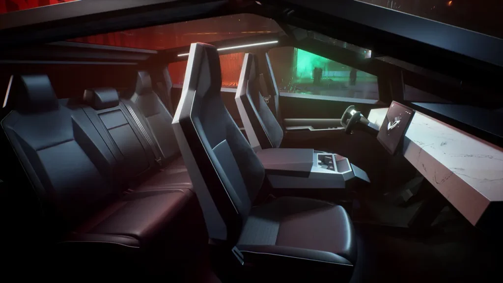 The interior of a 2024 Tesla Cybertruck is seen with a cool neon background behind it. 
