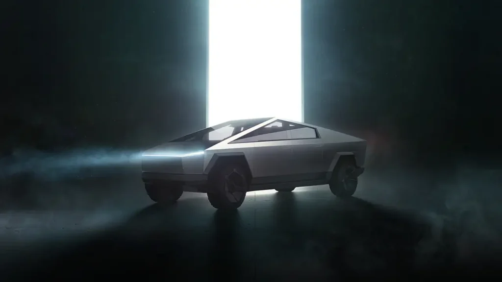 A 2024 Tesla Cybertruck is seen illuminated by a bright light. 