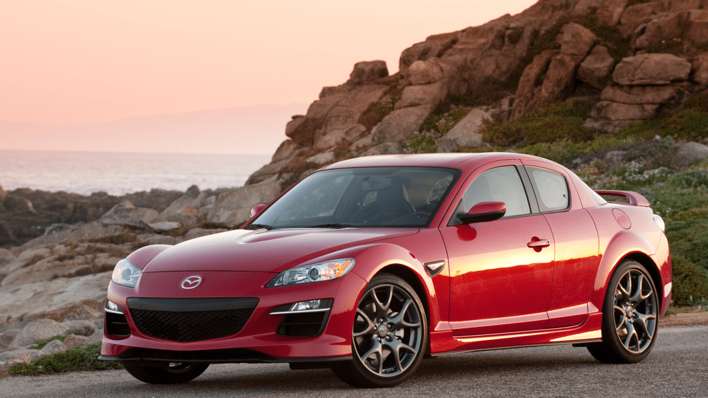 Mazda RX-8 parked by mountainside