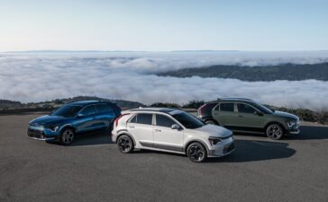 3 2024 Kia Niro compact crossovers on a mountain ledge overlooking the clouds
