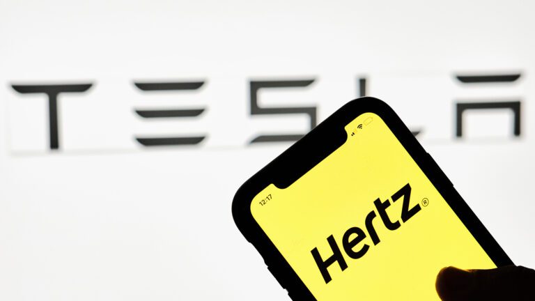 Hertz app running on an iPhone with Tesla logo in the background