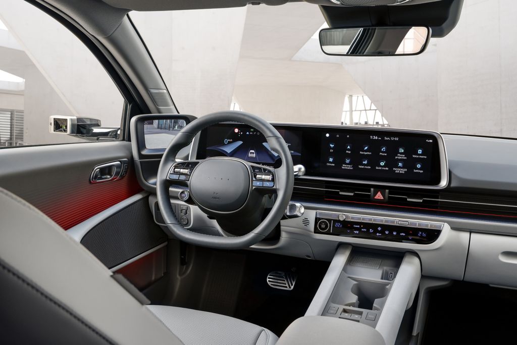 Hyundai IONIQ 6 interior looking into the driver's cockpit from the backseat