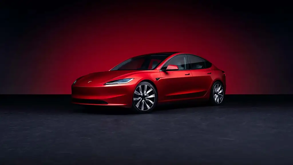 A red Tesla Model 3 is shown